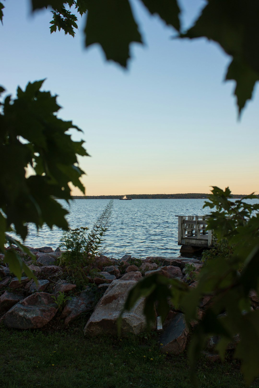 Calm lake at dusk with a pier, similar to the Minocqua, Wisconsin lake setting of the couple's backyard wedding