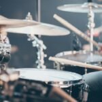 Drummer performing live on stage, representing Maxx Morando's career as a rock musician