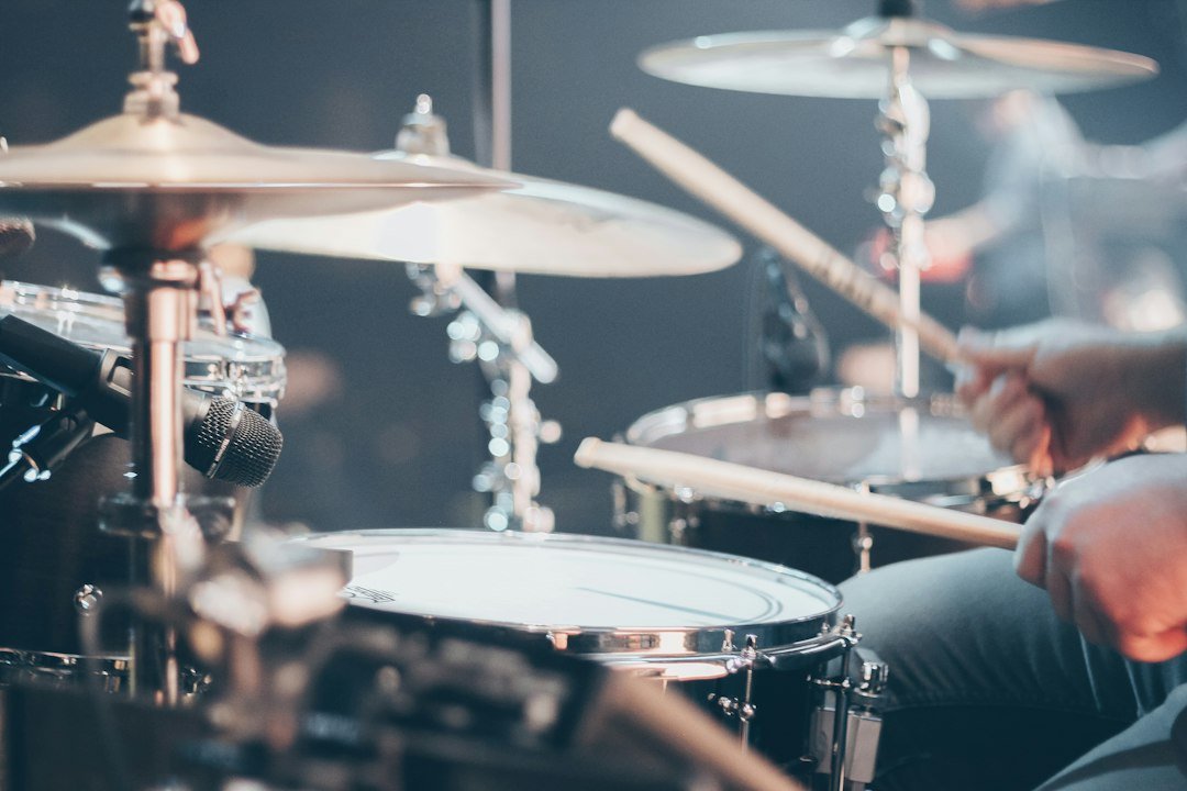 Drummer performing live on stage, representing Maxx Morando's career as a rock musician