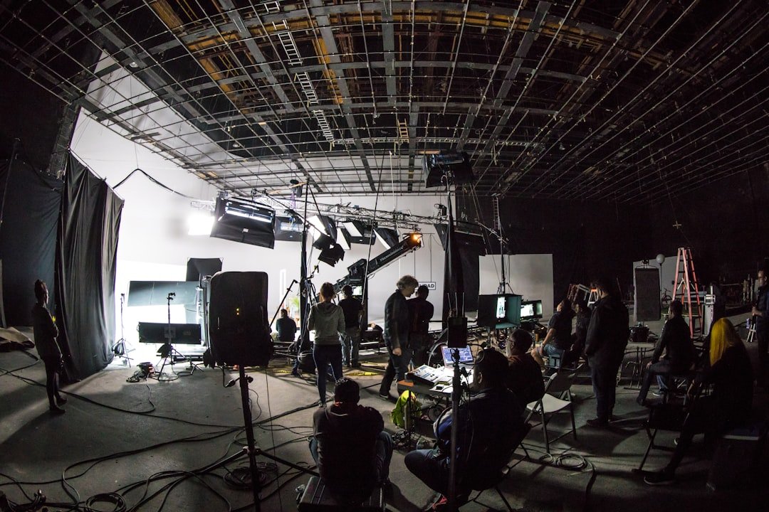 Film production soundstage with cameras and lighting equipment, representing the studio side of the entertainment industry