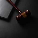 Gavel and law book representing the legal regulations surrounding brass knuckle knives