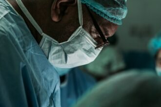 Orthopedic surgeon in medical scrubs representing Dr. Daniel Christopher Allison's career in orthopedic oncology